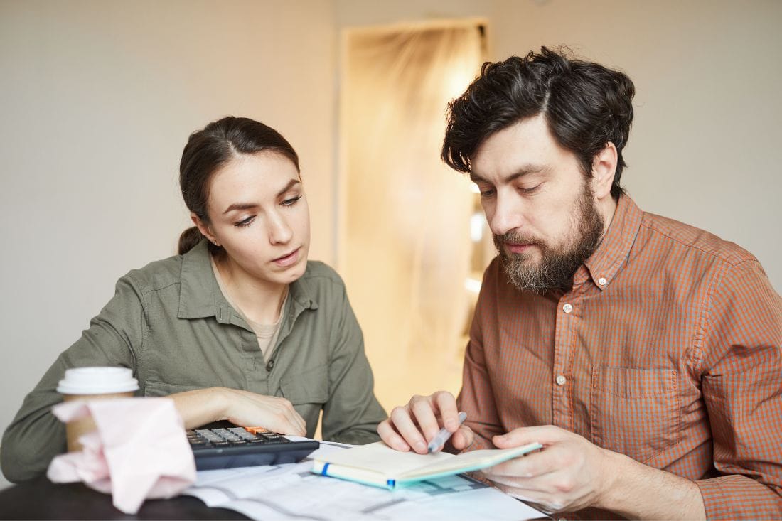 Husband and Wife Calculating Cost Of Moving Interstate Before Moving